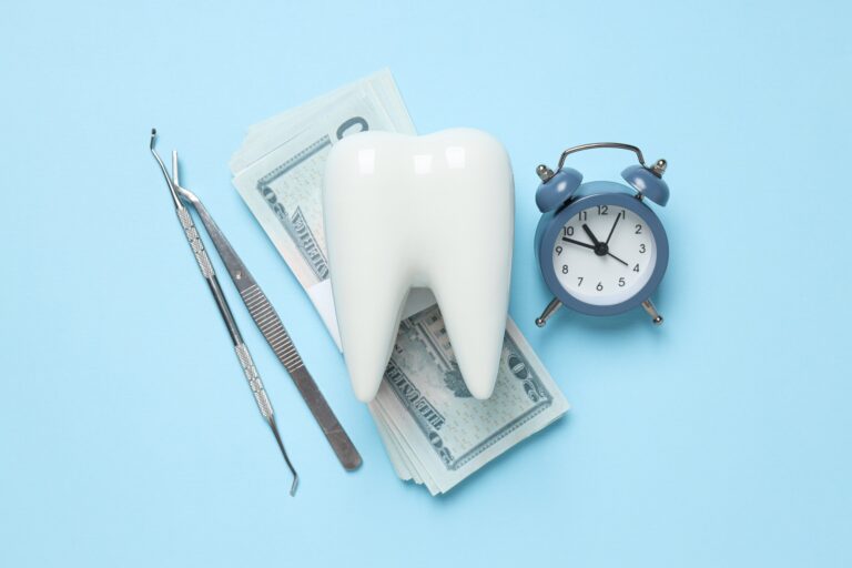 Clock, dental tools, decorative tooth and money on blue background, top view