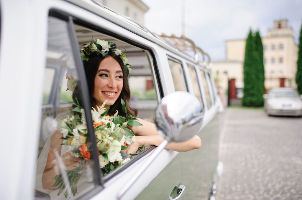 Bride driving a retro bus.