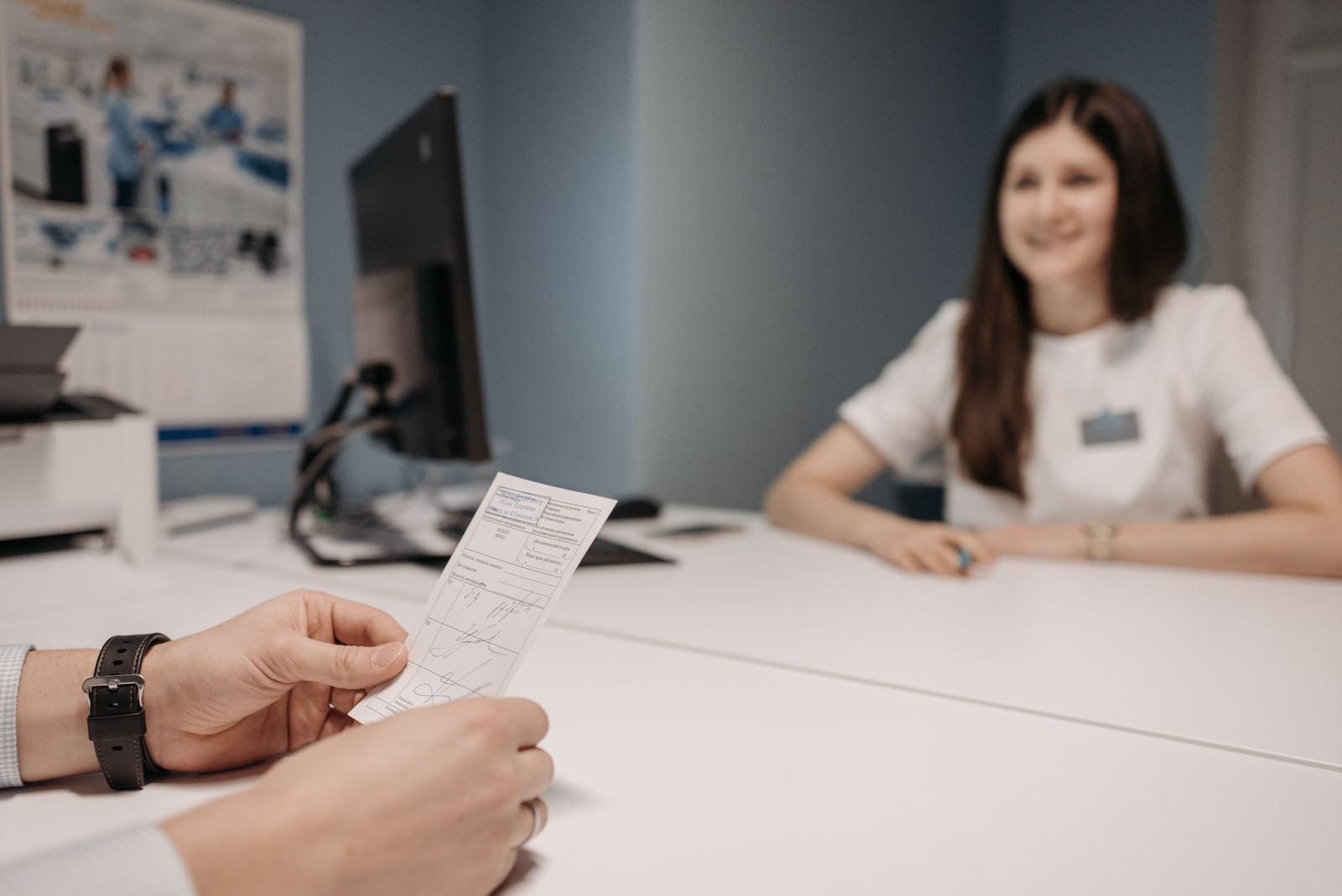 Woman doctor discussing patient's prescription in a clinic office setting